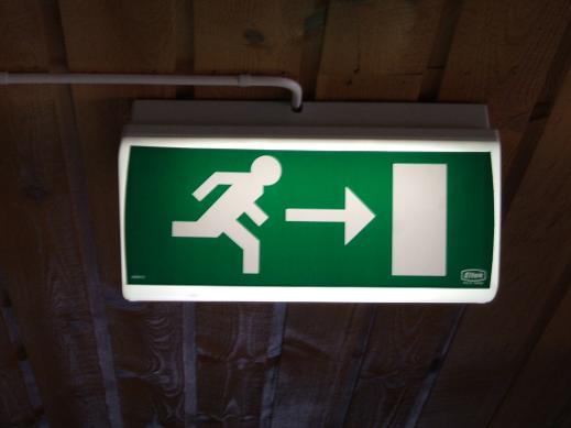 emergency exit sign. Denotation is what the sign is